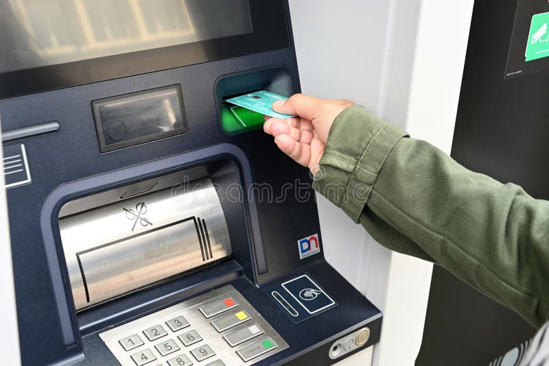 close up atm someone putting their bank card machine person inserting bank card atm 327942114